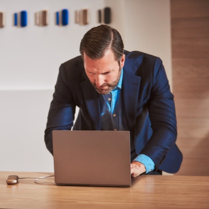 Man reviewing Support page on a Laptop